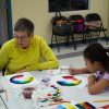 Woman and girl painting color wheels